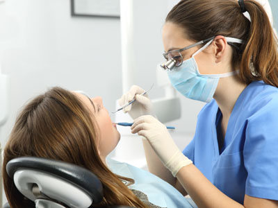 Woman receiving dental care from a professional in a dental office.